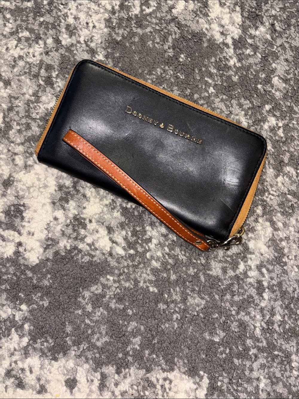 Dooney & Bourke Black Leather Zip-Around Wallet with Brown Trim and Wrist Strap